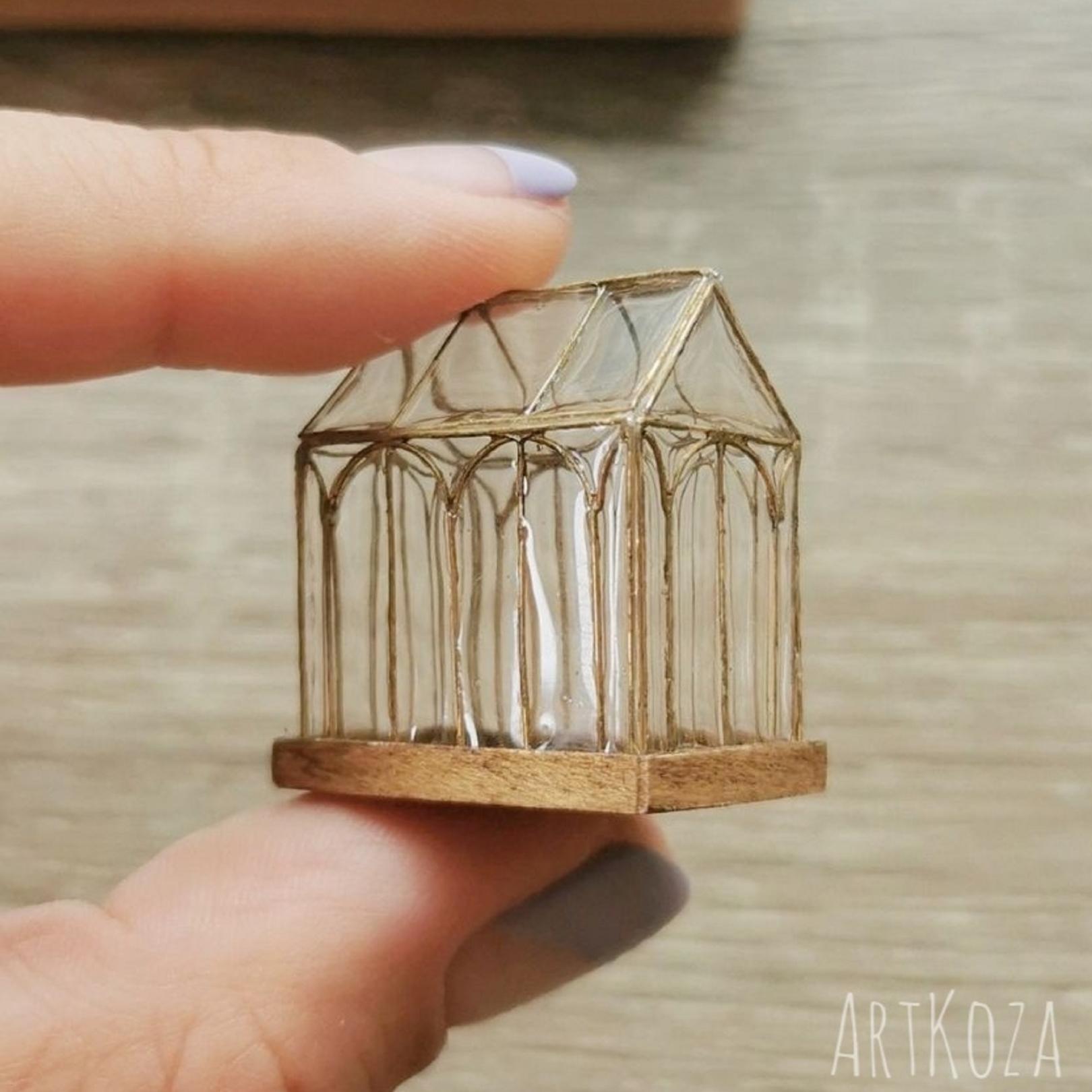Modern miniature greenhouse on flat tray Modern miniature greenhouse on flat tray