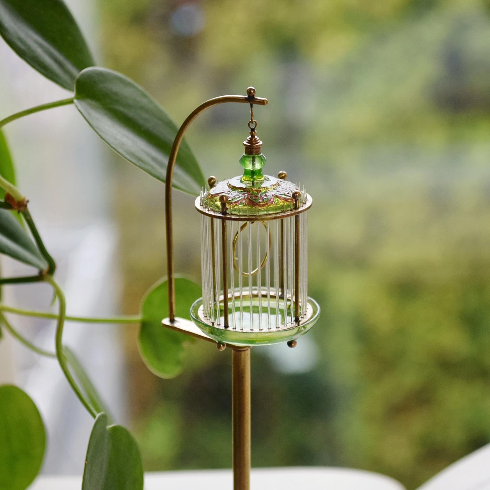 Italian glass birdcage on the metal stand