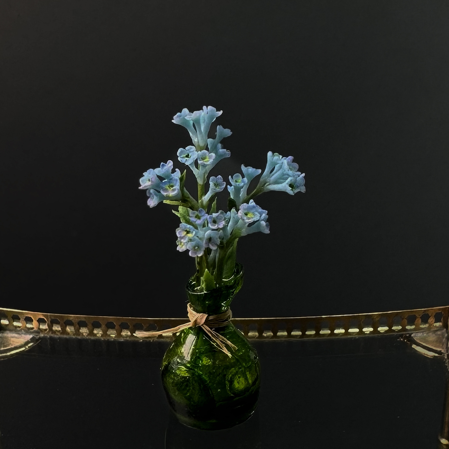 Forget-me-nots in the green vase.